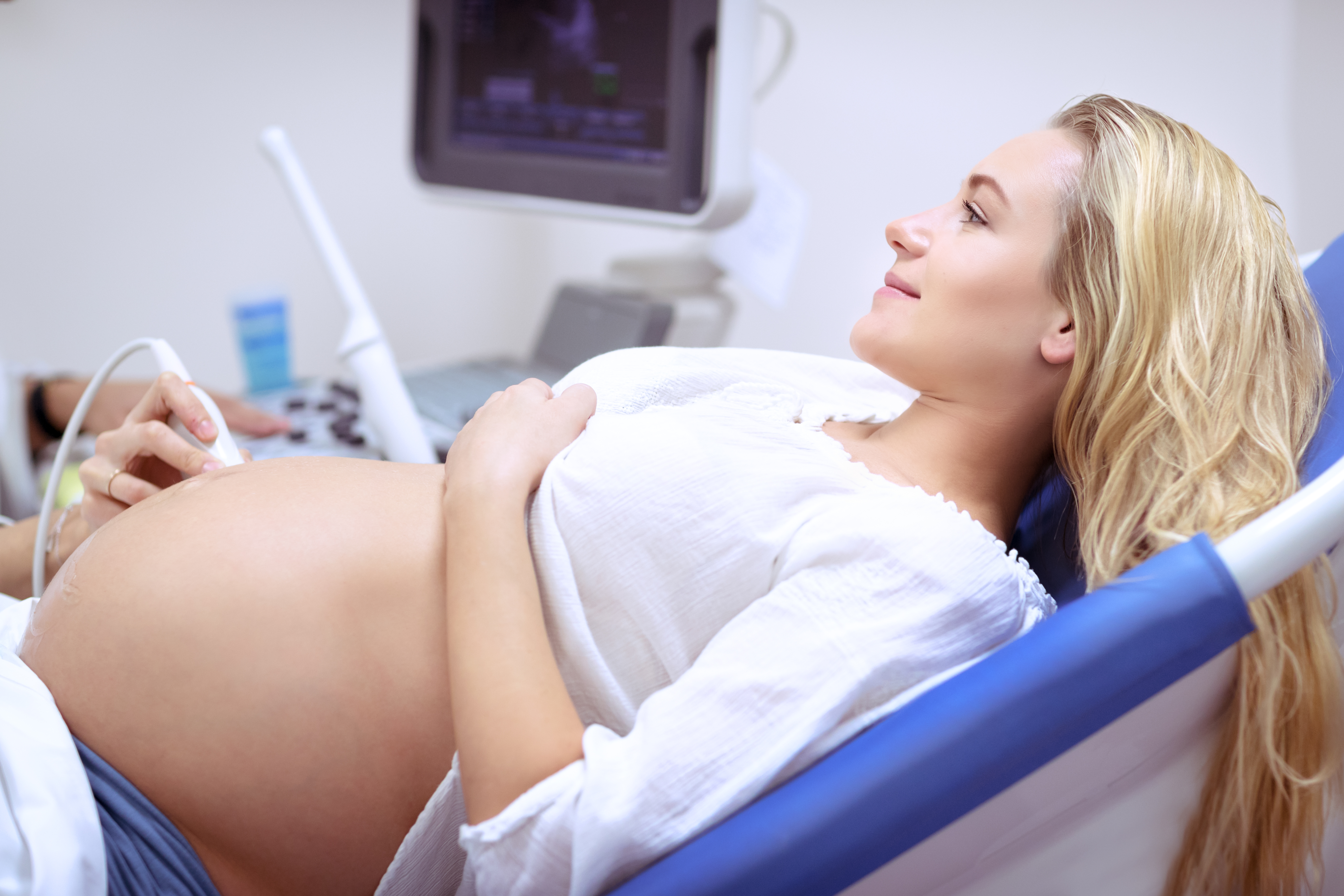 image of happy pregnant woman  waiting to receive IV therapy for pregnancy