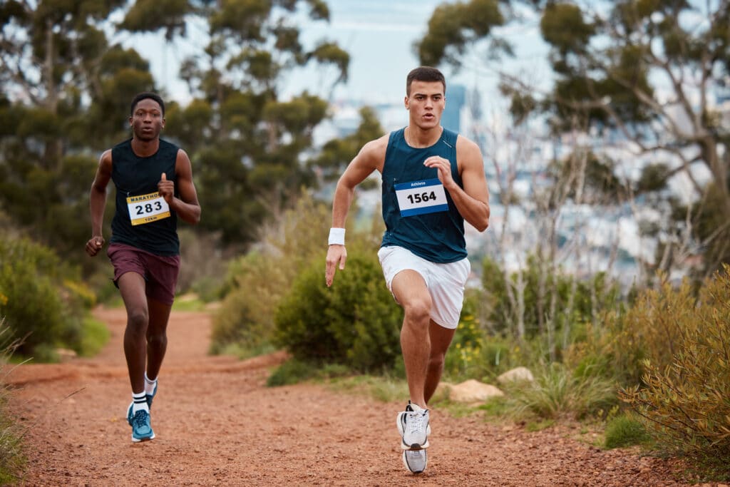 image of two men running on track after iv therapy for athletic performance